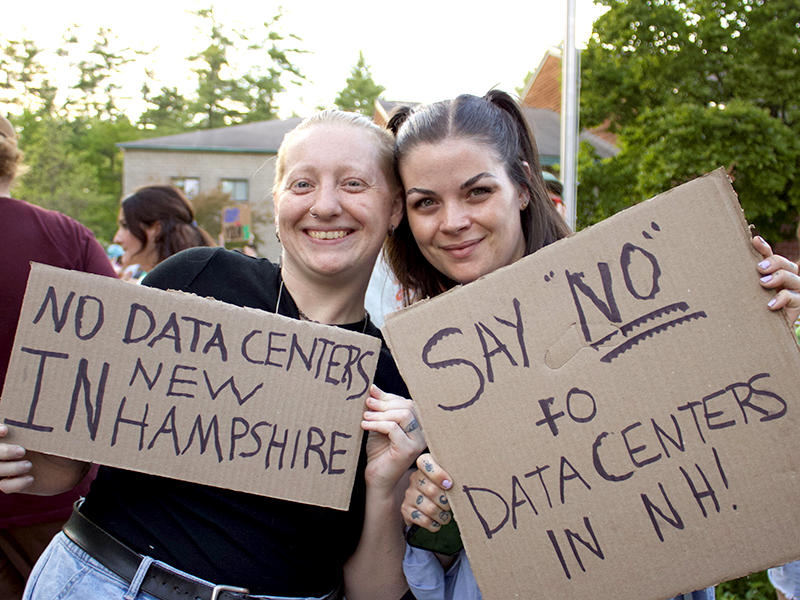 Heather Deiner and a fellow protestor holding signs